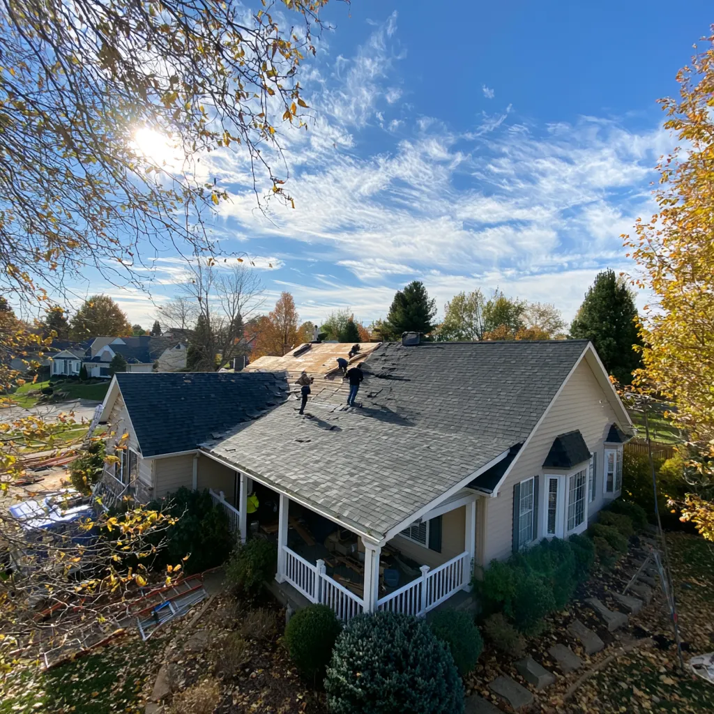 House roof seen from above as roofers strip shingles